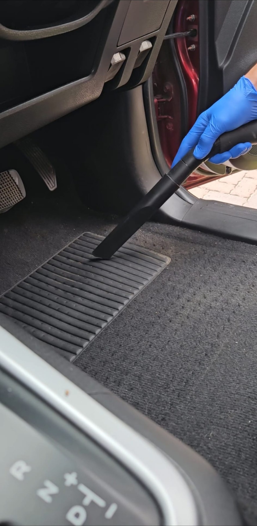 Vacuuming the driver footwell and mat