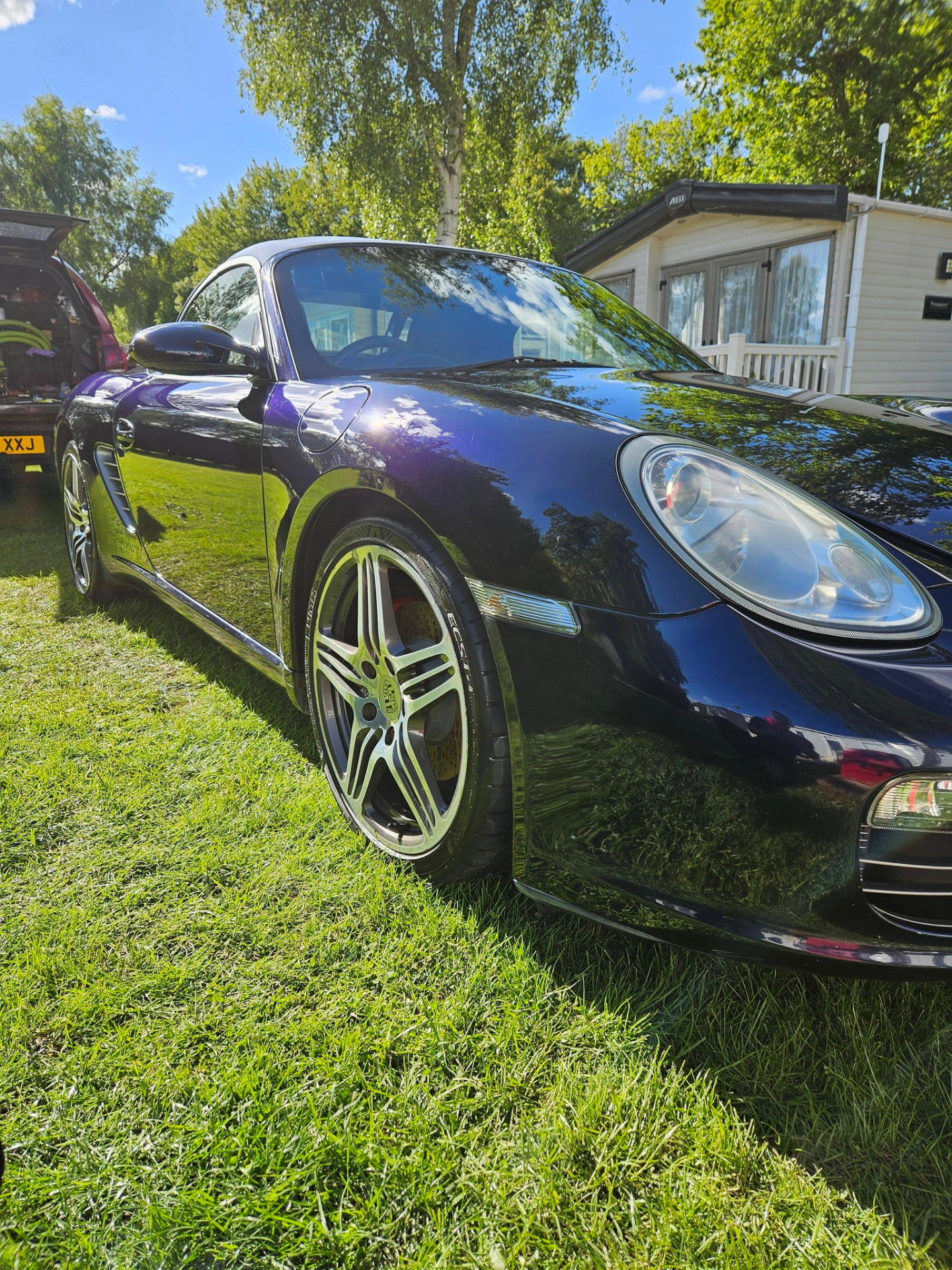 Dark blue Porsche Boxster with reflective paint after detailing