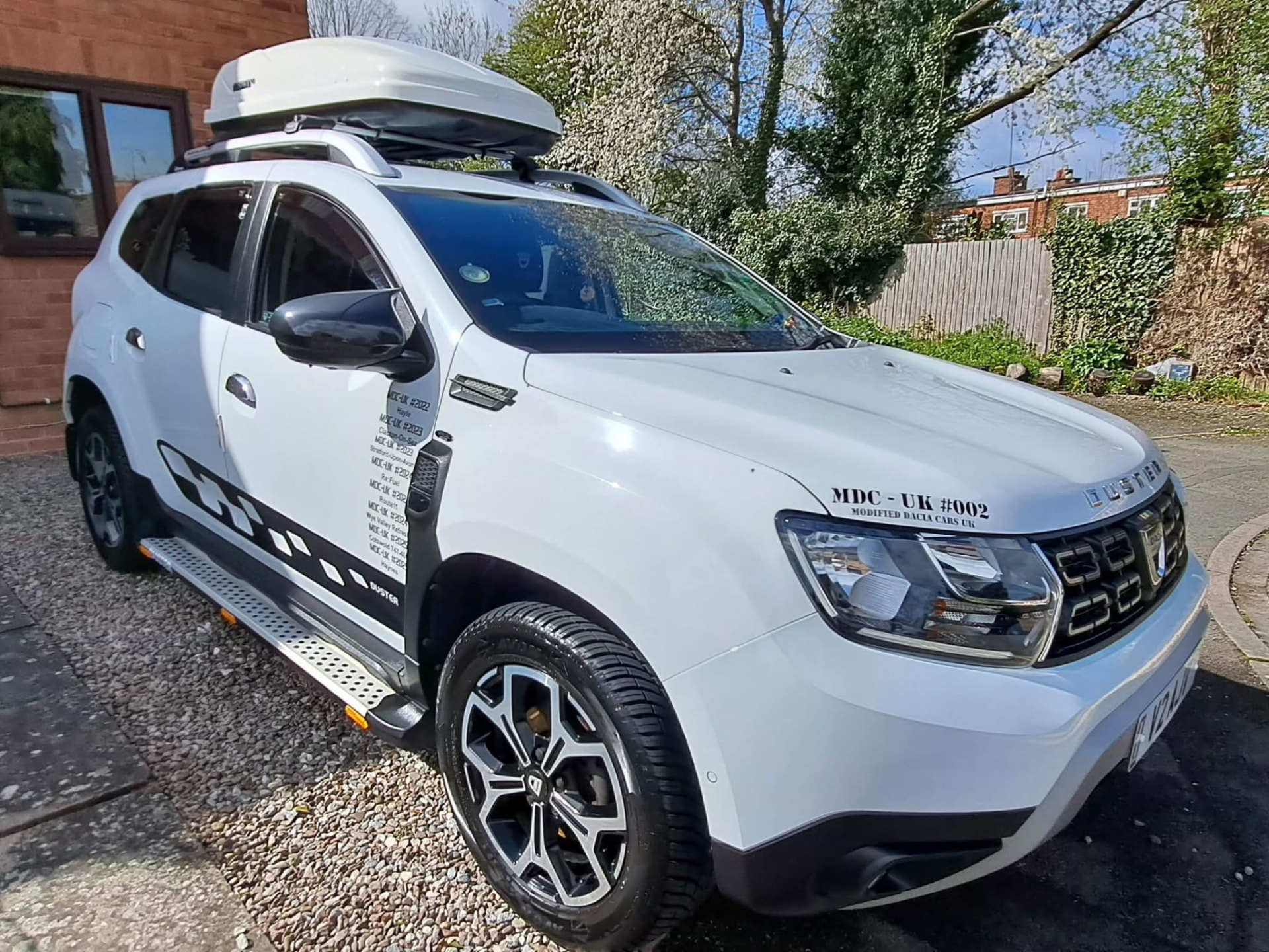 White Dacia Duster cleaned outside a customer's home