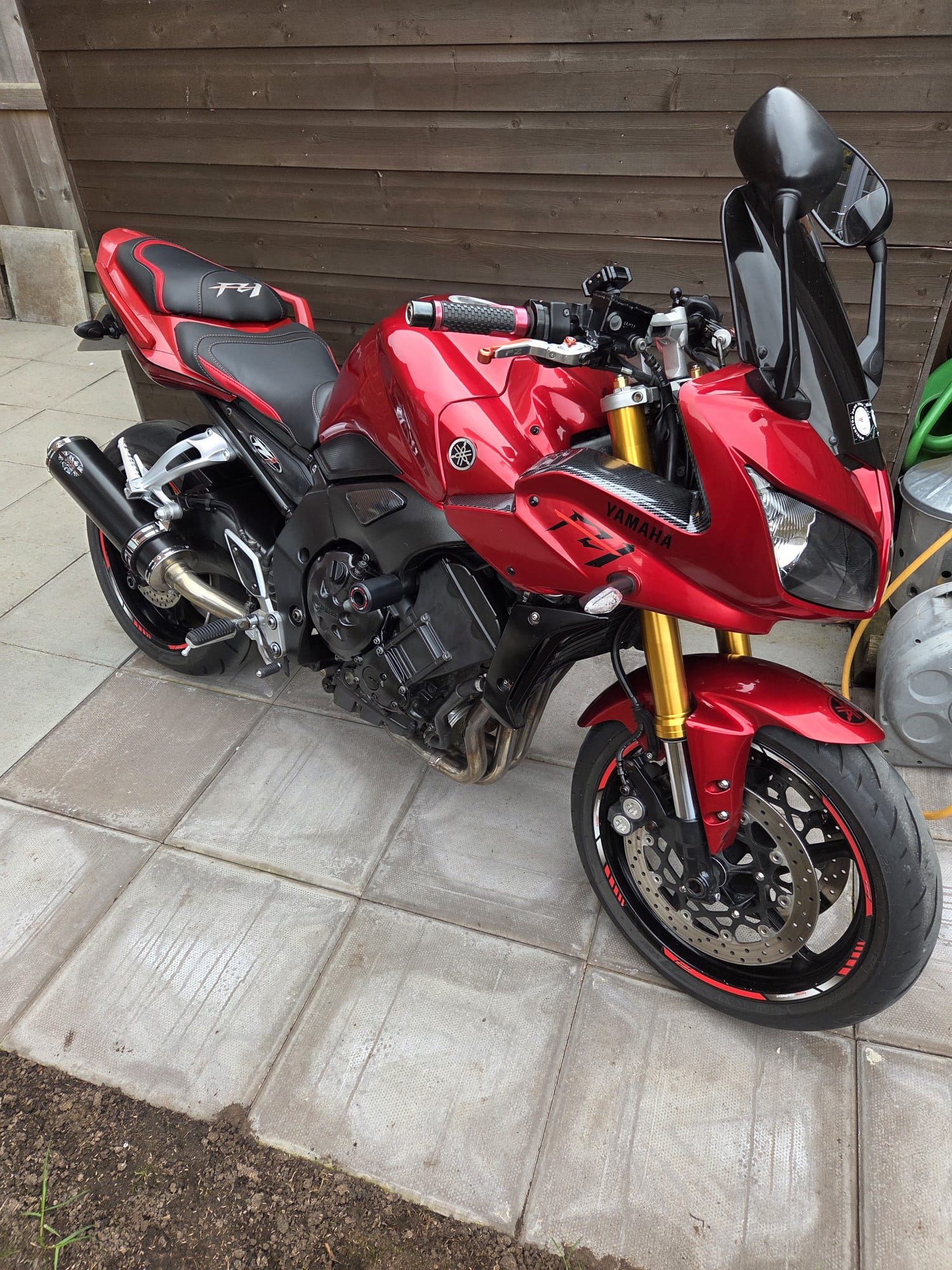 Red sports motorcycle detailed by Jeynes Cleans on a customer's patio