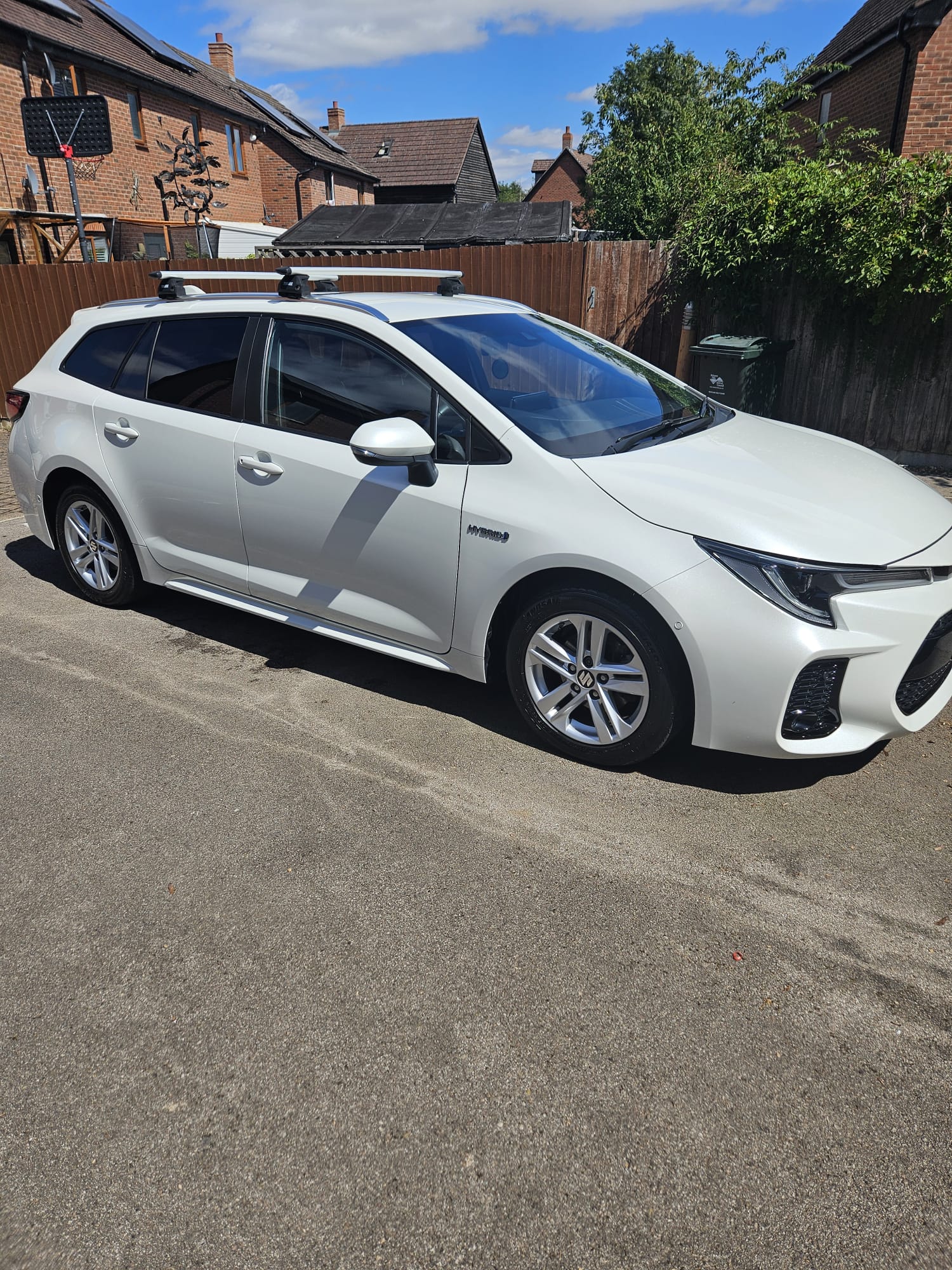 White Toyota Corolla estate cleaned on a residential street